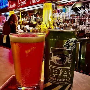 a beer and a can on a bar
