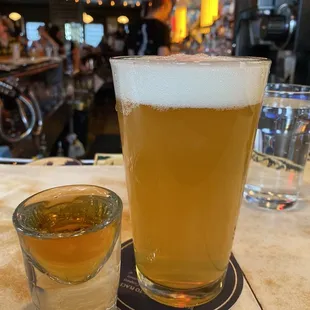 a glass of beer and a shot