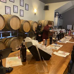 a wine tasting area with wine barrels