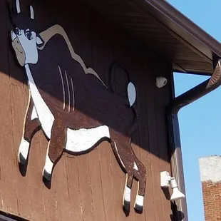 a cow painted on the side of a building