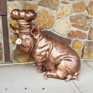 a statue of a dog wearing a chef's hat