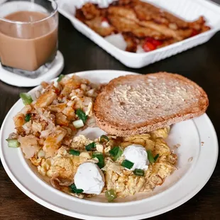 Gail's Favorite Eggs with side of Lyonnaise potatoes, and toast; strawberry pancake crepes in the back.