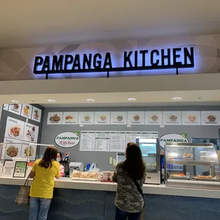 two women standing in front of the counter