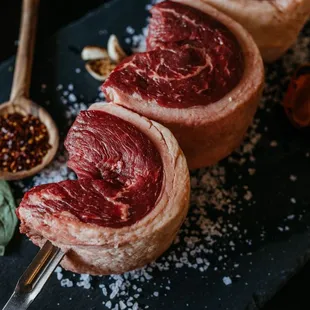three steaks on a slate board