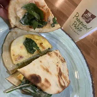 a hand holding a piece of bread