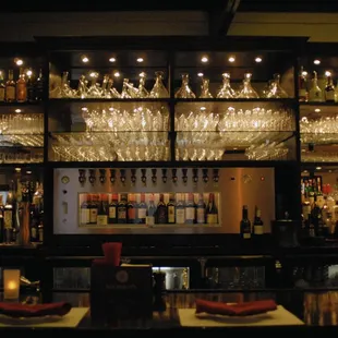 a bar with many bottles of alcohol