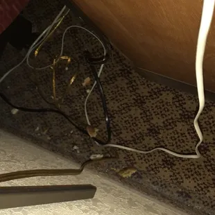 Filth behind the nightstand when I went to plug in the lights
