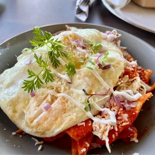 Chilaquiles Texanos with chicken and eggs added for an upcharge. Big on portion and flavor!