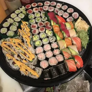 a platter of sushi and rolls