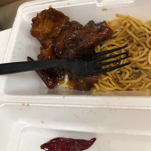 a fork and noodles in a styrofoam container
