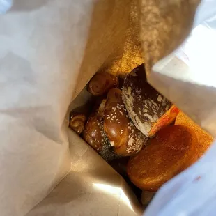 a variety of pastries in a paper bag