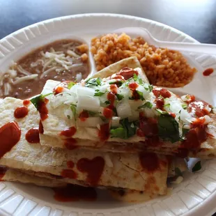 Chicken quesadilla with cilantro, onions and hot salsa on top. Yum