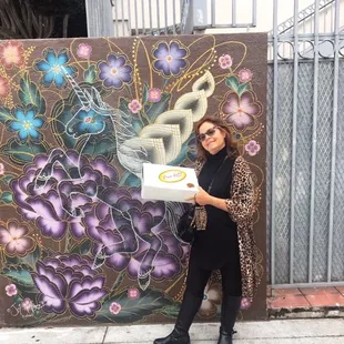 Enjoying the street art with our box of treats