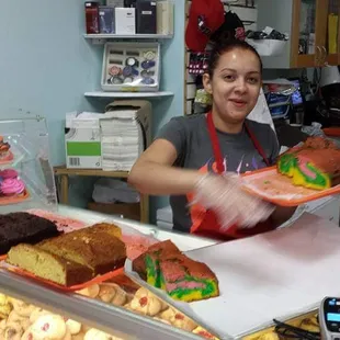 a woman serving pastries
