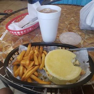 Breakfast arepa, egg tomatoes green onions and cheese.
