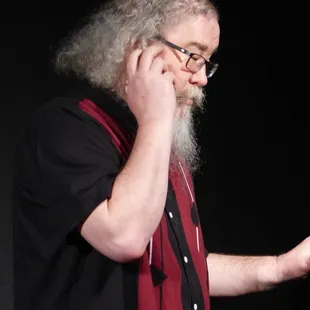 a bearded man talking on a cell phone