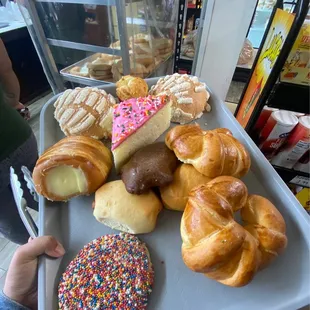 a tray of doughnuts and pastries