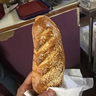 a person holding a loaf of bread