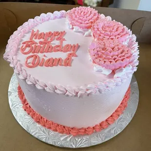 a pink and white birthday cake