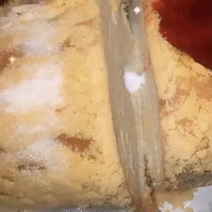 a person cutting into a pastry