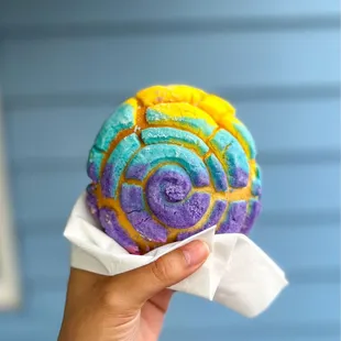 a hand holding a pastry