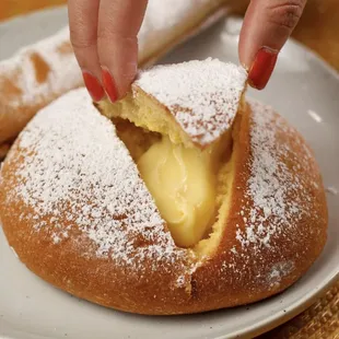 a person putting a piece in a pastry
