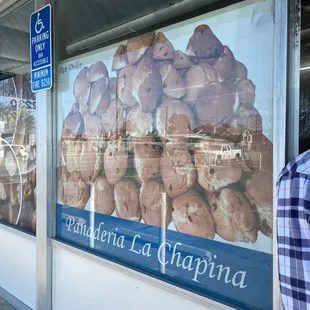 a man standing in front of a bakery