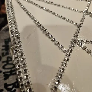 a panaderia cake decorated with silver beads