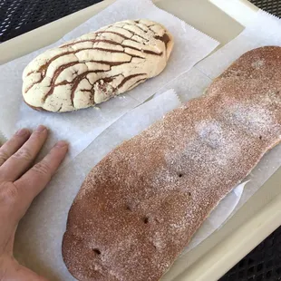 a person&apos;s hand reaching for a pastry