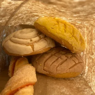 Got some conchas, I don't know the name of the other item but theres strawberry filling inside.