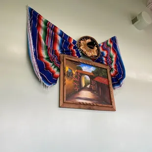 a picture of a mexican flag hanging on a wall