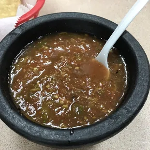 a bowl of chili with a spoon