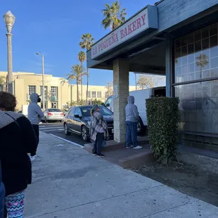 people standing outside of a building