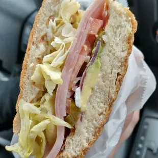 a person holding a sandwich
