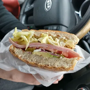 a person holding a sandwich