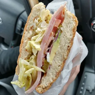 a person holding a sandwich