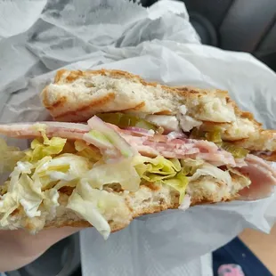 a person holding a sandwich