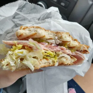a person holding a sandwich