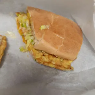 Breakfast sandwich with eggs ham peppers lettuce tomato  delicious