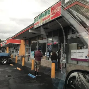 people standing outside of a restaurant