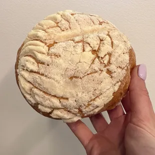a hand holding a pastry