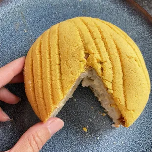 Like a concha but not dry. Very light smear of cajeta (caramel) under that crusty top. No filling. $4 or 3/$10 mix/match.