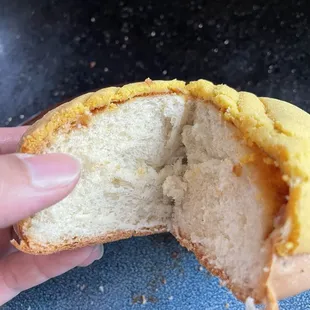 Inside the concha-like bun. Not dry like a concha. Needs more topping or a filling. $4 or 3/$10 mix/match.