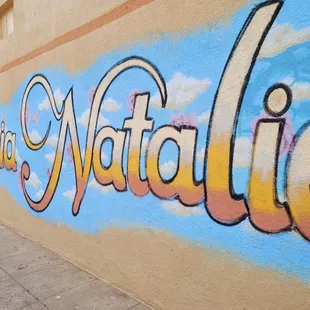 the name of a mural on the side of a building