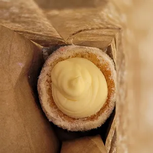 a cupcake in a paper bag