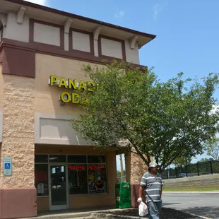 a man standing in front of a restaurant