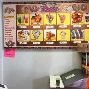 a woman standing in front of a menu board