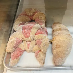 a variety of pastries in a display case