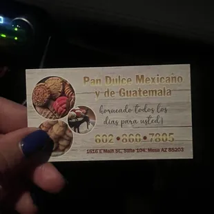 a hand holding a business card