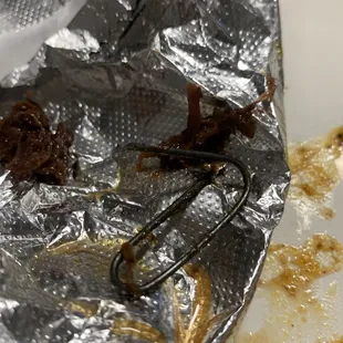 a piece of tin foil with food on it
